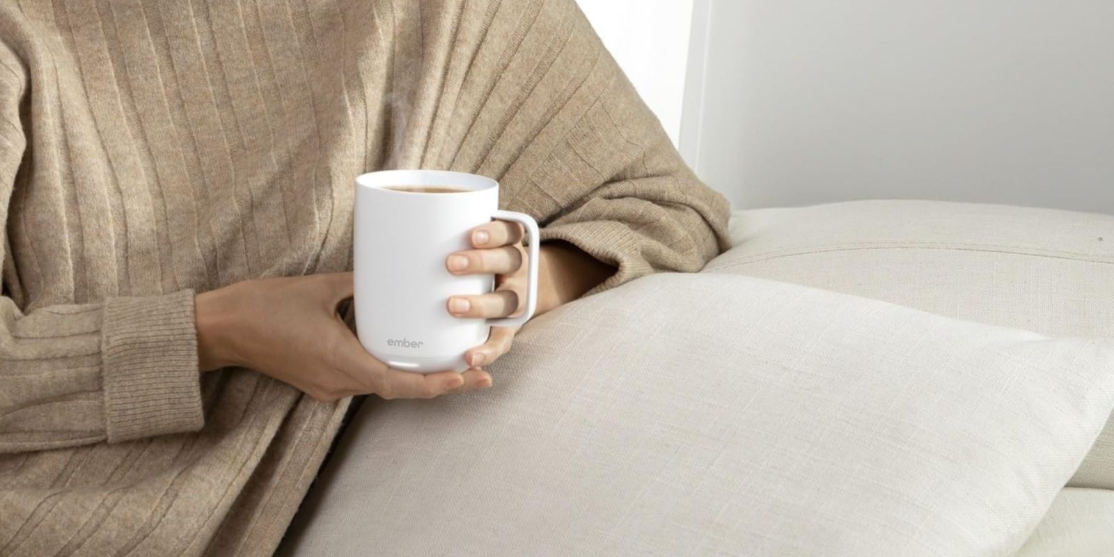 Image showing a person holding Ember's Smart Mug 2 in white.