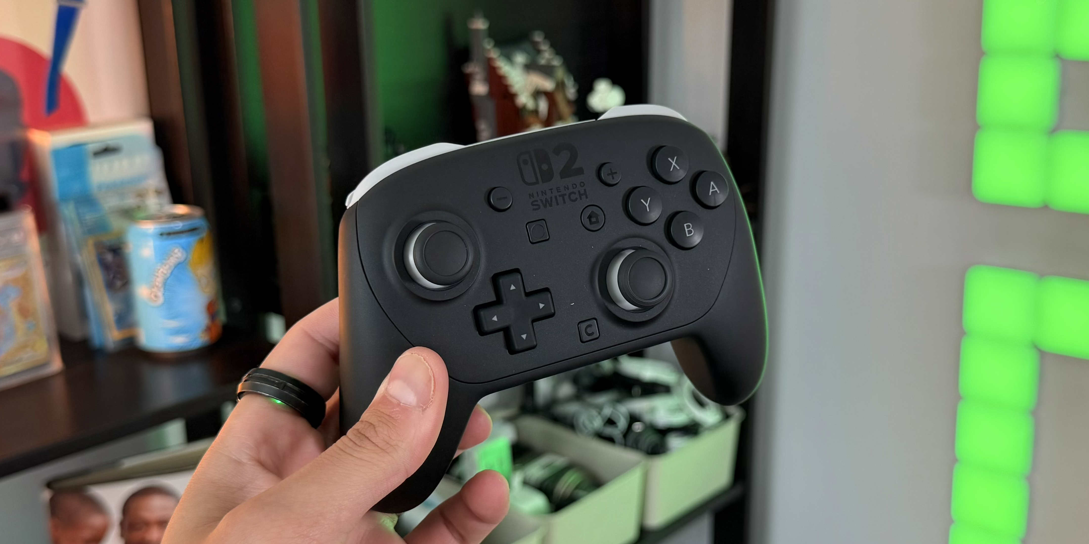 A hand holding a video game controller