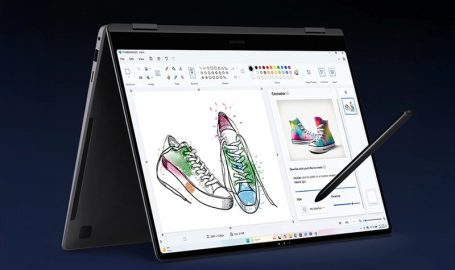 A laptop with a pen on the screen