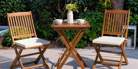 A table with cups and a vase of flowers on it