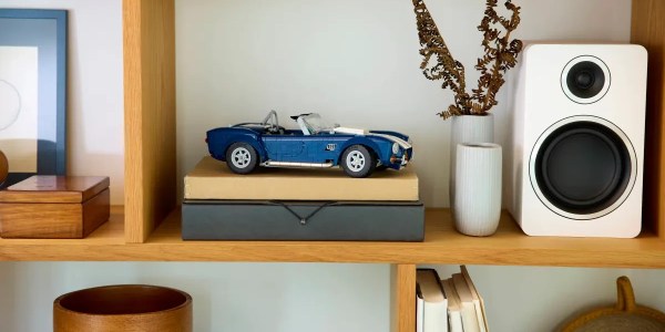 A toy car on top of books on a shelf