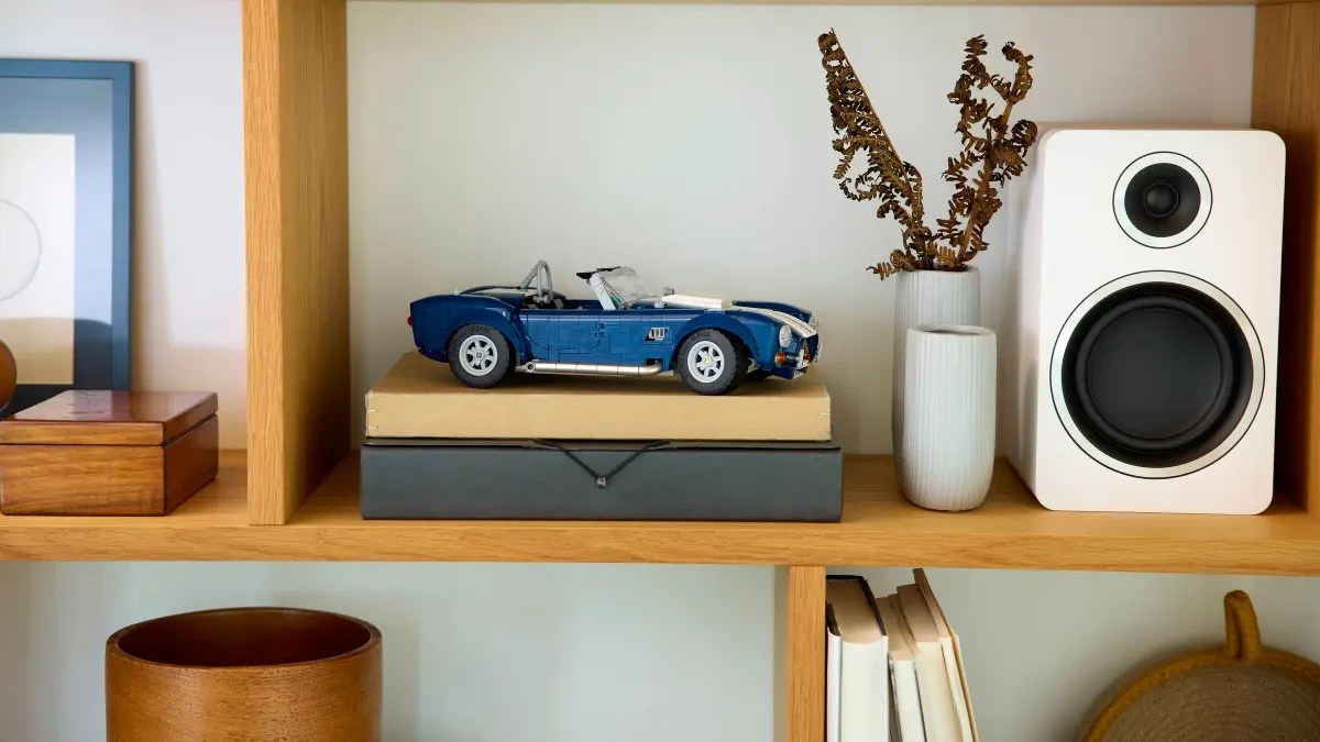 A toy car on top of books on a shelf