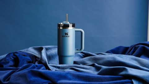 A blue coffee mug on a blue blanket