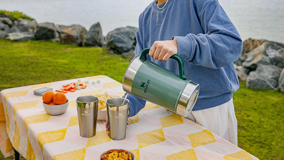 A person pouring water into cups