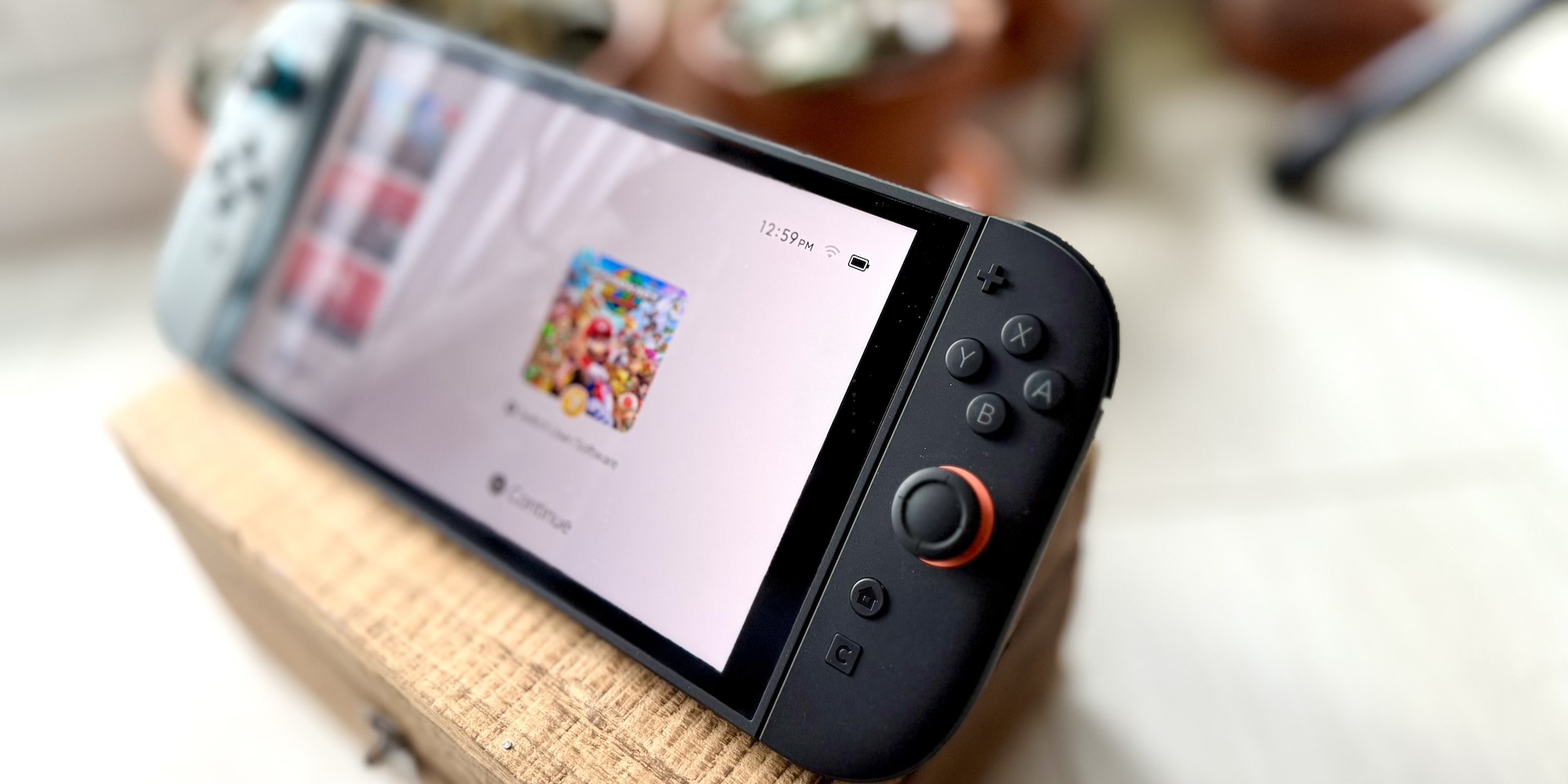 A black gaming device with buttons and a white screen