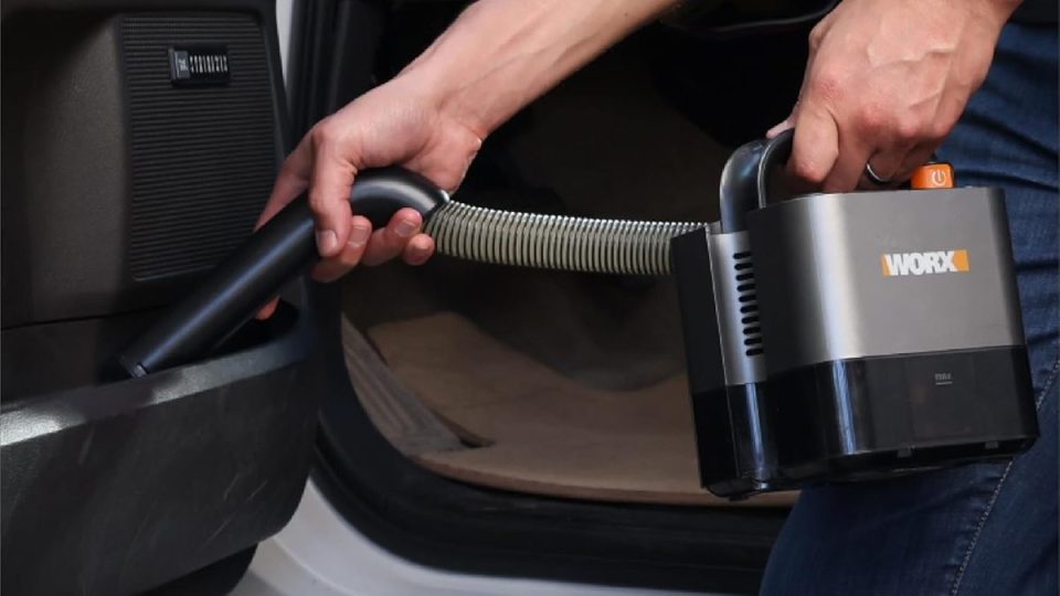 A person holding a vacuum cleaner