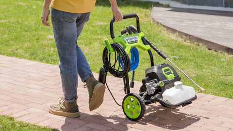 A person walking with a lawnmower