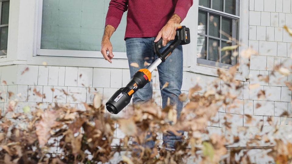 A person holding a leaf blower