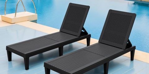 A pair of black chairs next to a pool