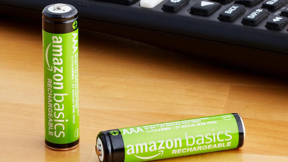 A green batteries next to a remote