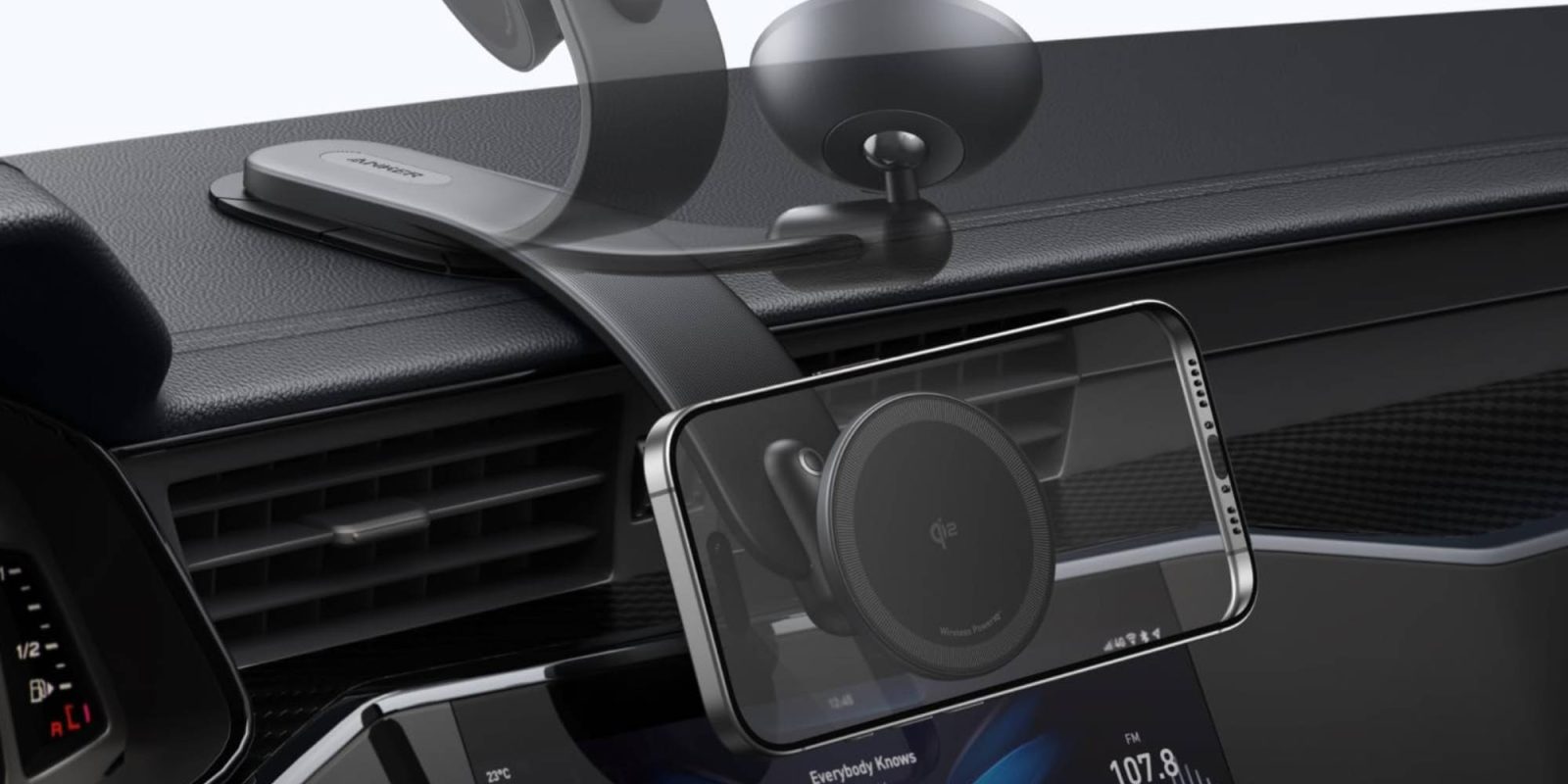 A car dashboard with a phone and a screen