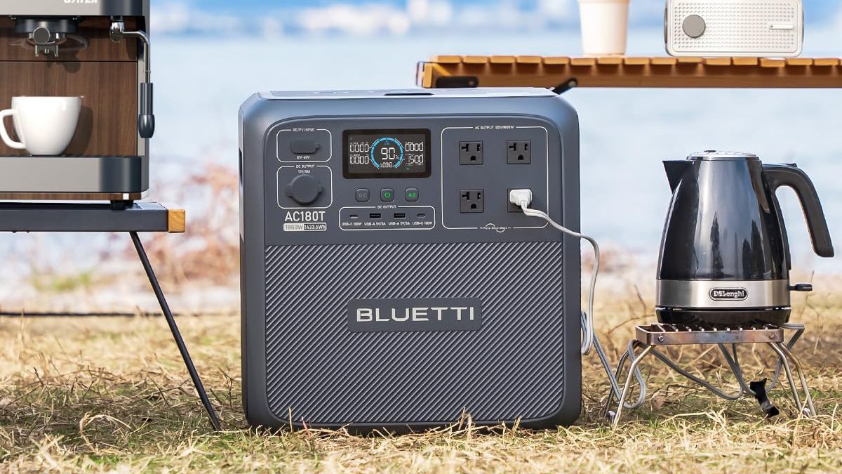 A square black device with a white cord plugged into it