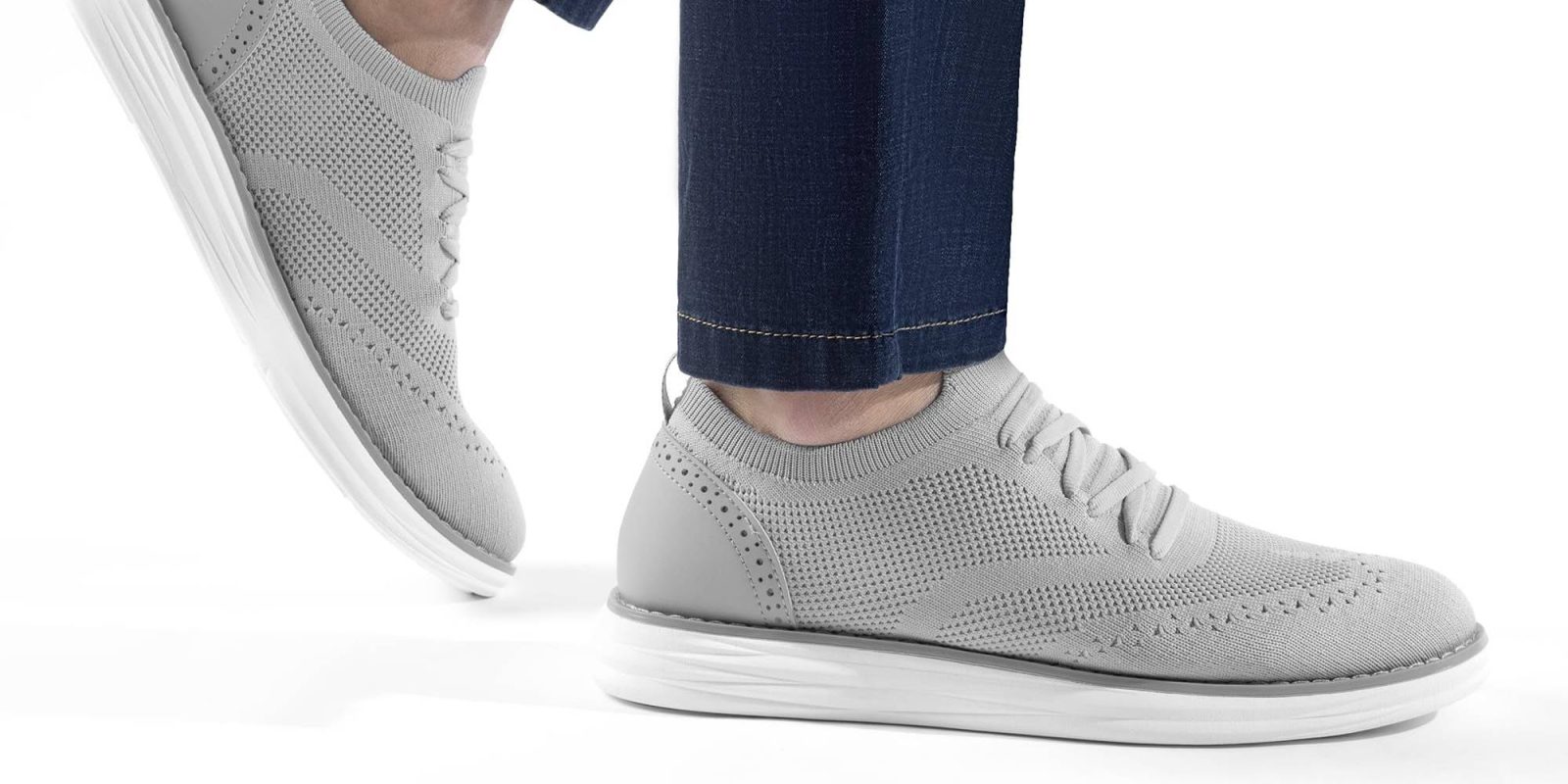 A person's feet in grey shoes