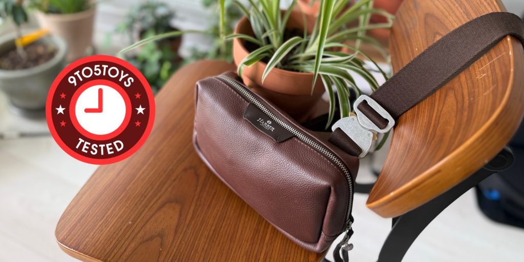 A brown leather belt bag on a table