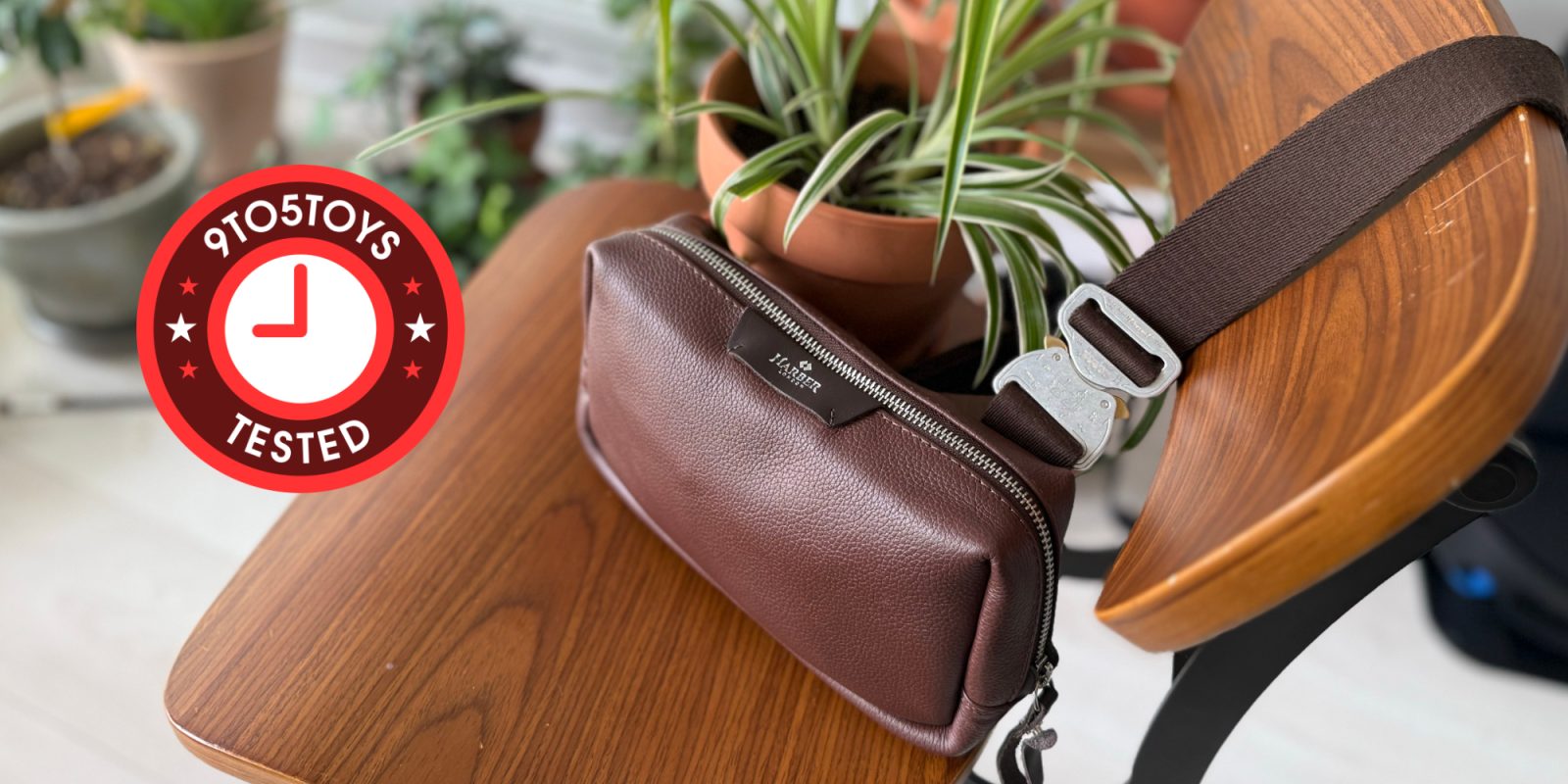 A brown leather belt bag on a table