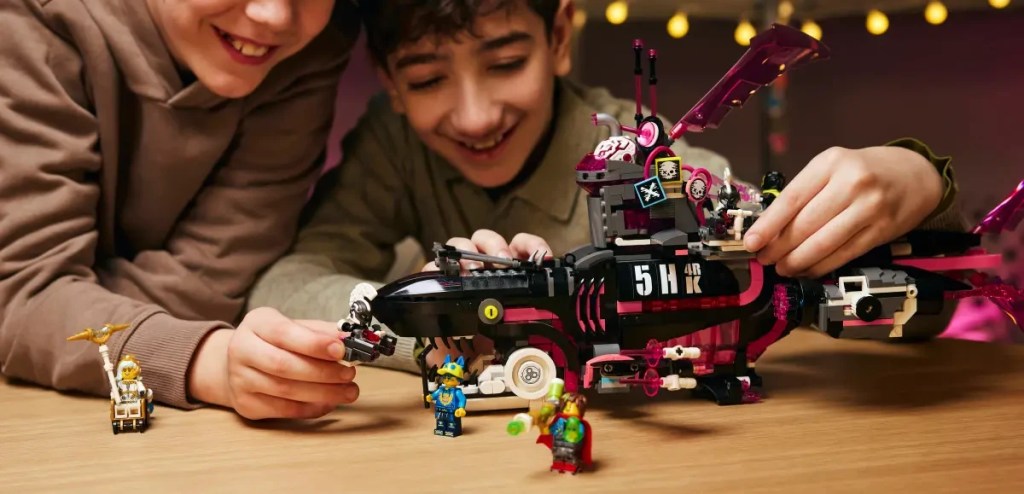 A boy and a boy playing with a toy