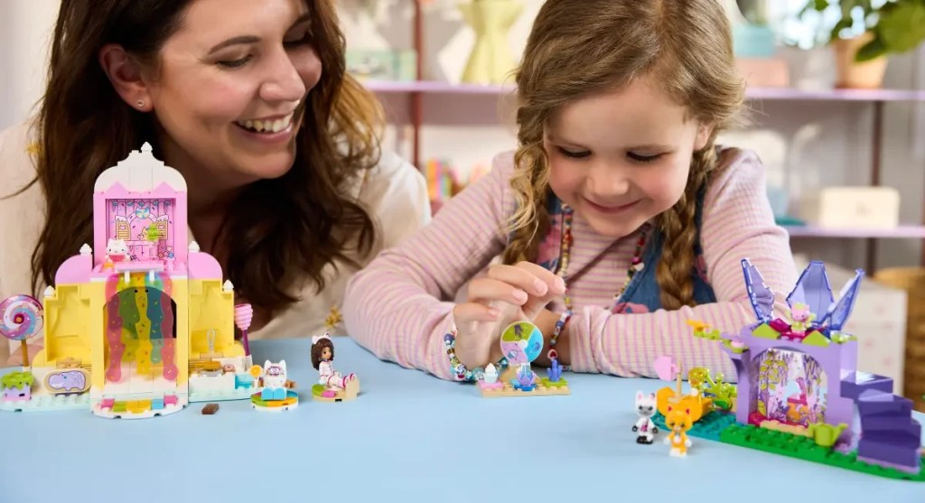 A woman and a girl playing with toys