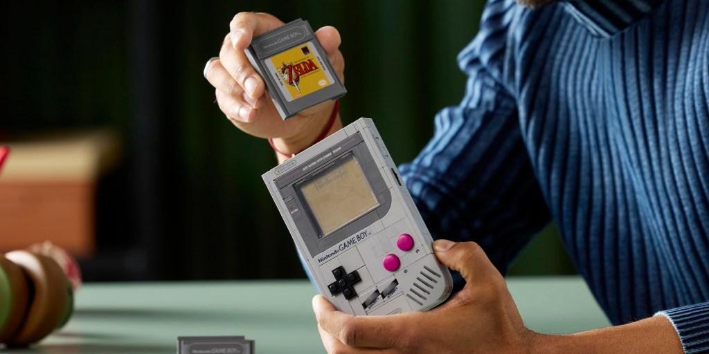 A person holding a handheld game console