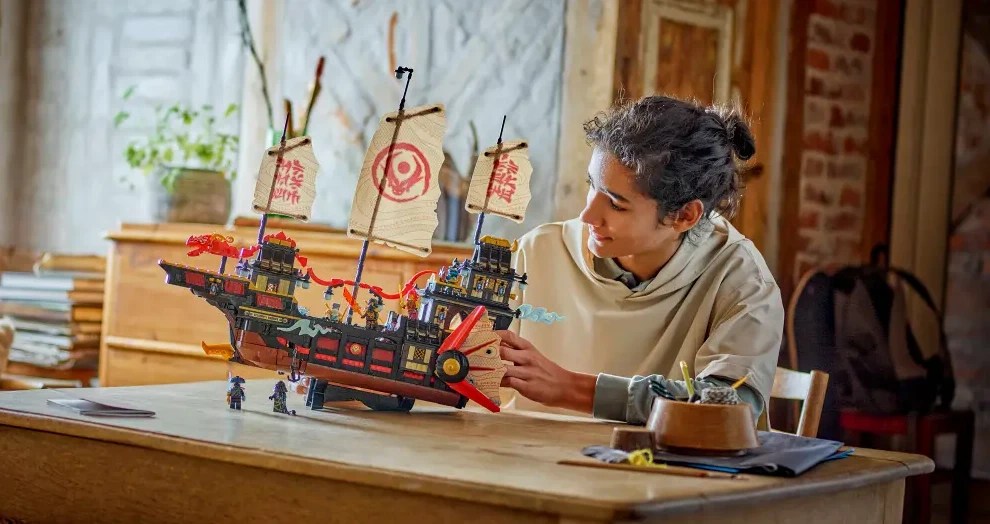 A boy playing with the LEGO Ninjago temple bounty set