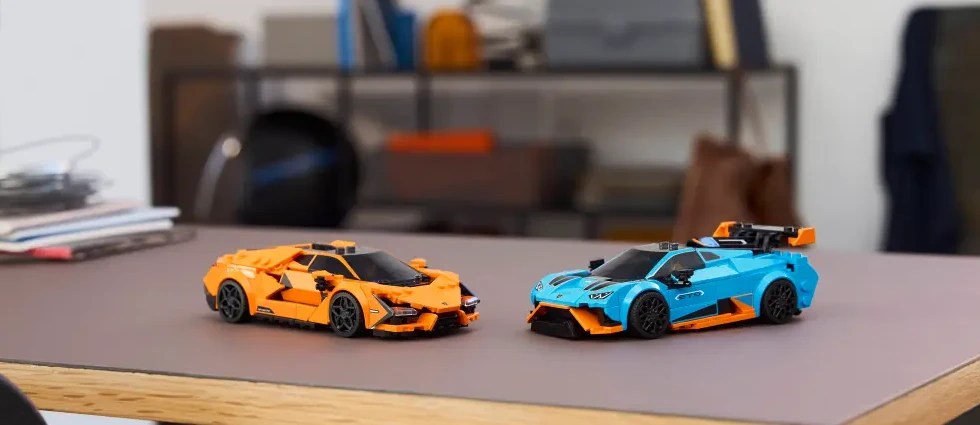 Two LEGO Technic cars on a table