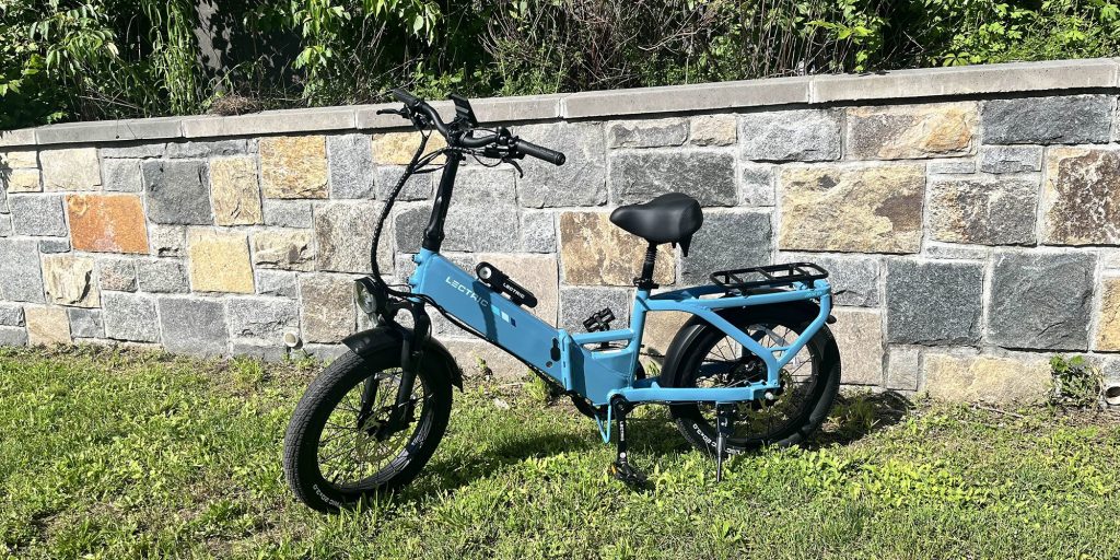 A blue e-bike parked in the grass