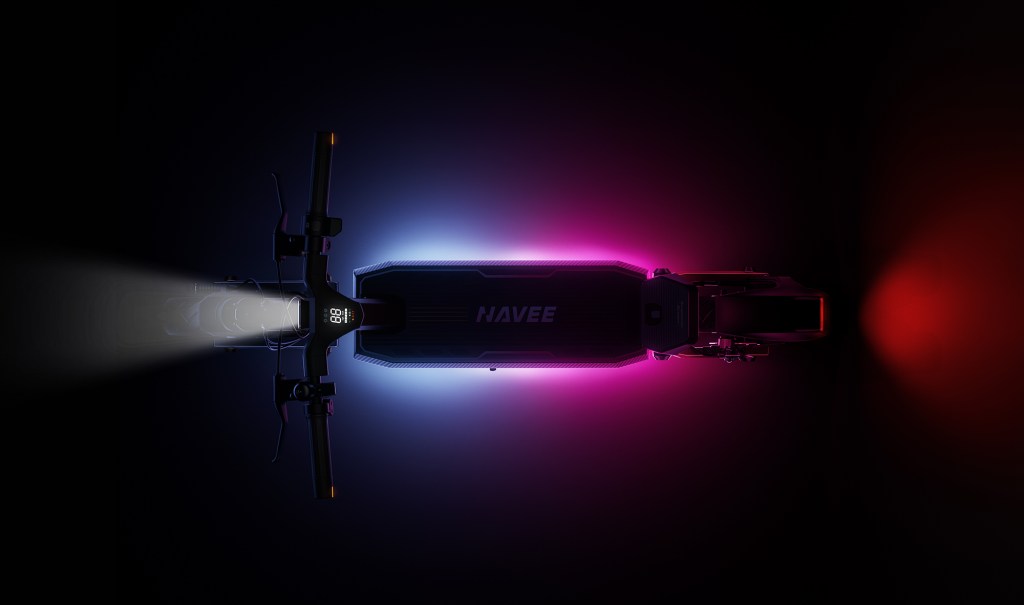 A black and pink scooter with a white light