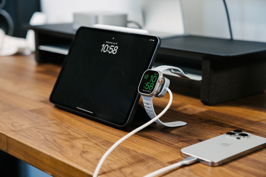 A smart watch and tablet on a table