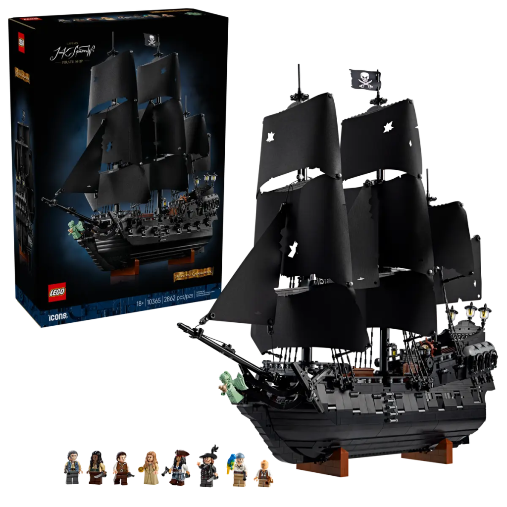 A toy ship with black sails and a box