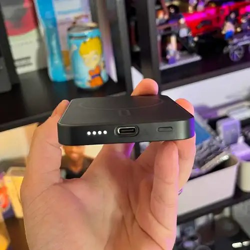 A hand holding a device