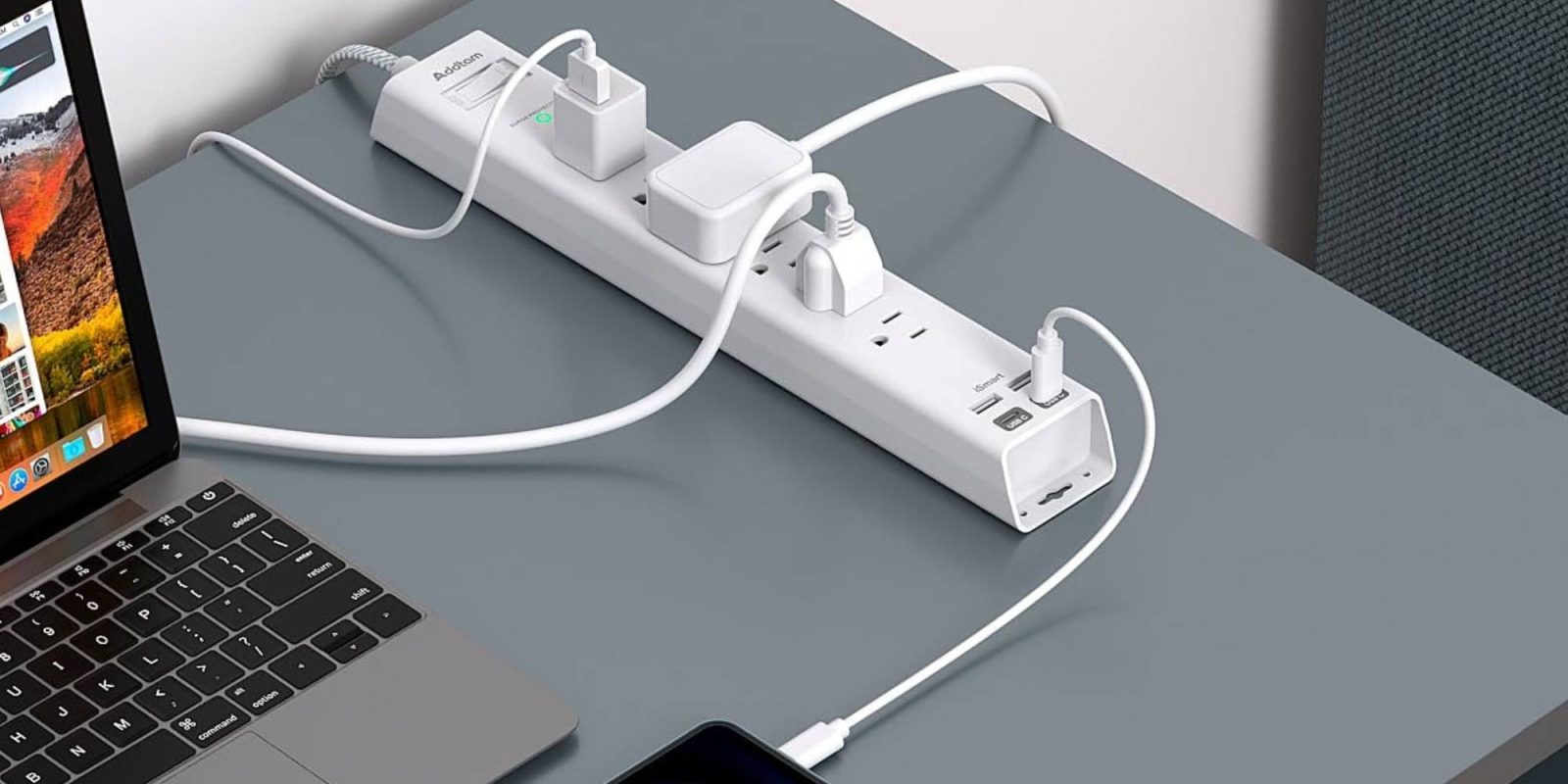 A power strip with multiple plugs connected to a cell phone