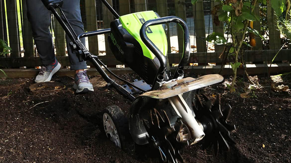 A green and black machine in dirt