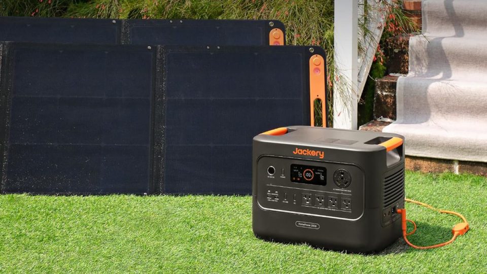 A solar panel next to a power generator