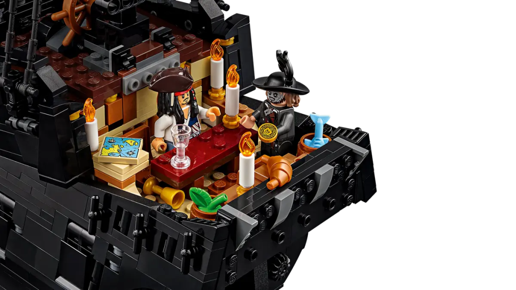 A lego pirate ship with a table and two lego pirates