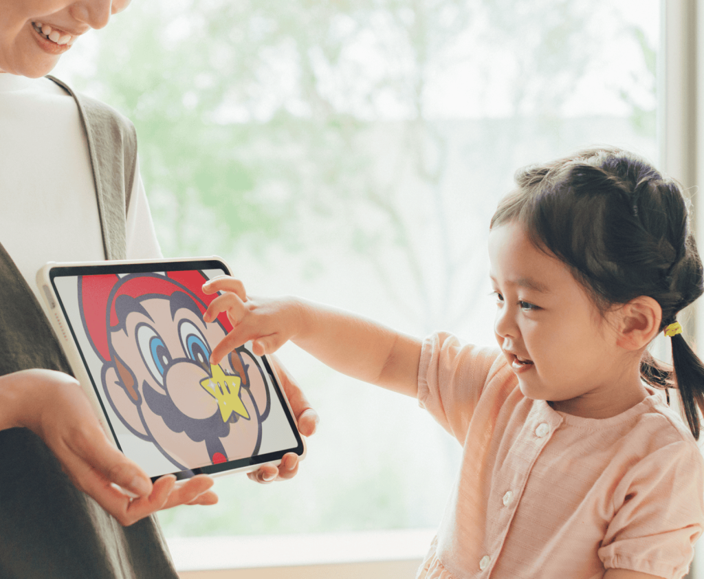 A child and a woman holding a tablet