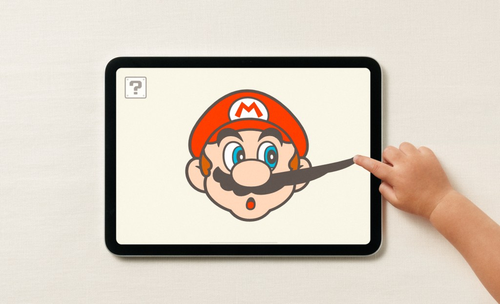 A hand pointing at a cartoon character on a tablet