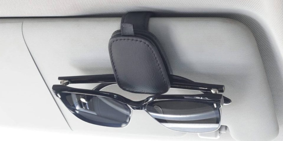 Sunglasses on a holder in a car