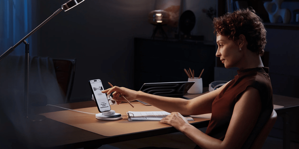 A woman using a phone to display a screen