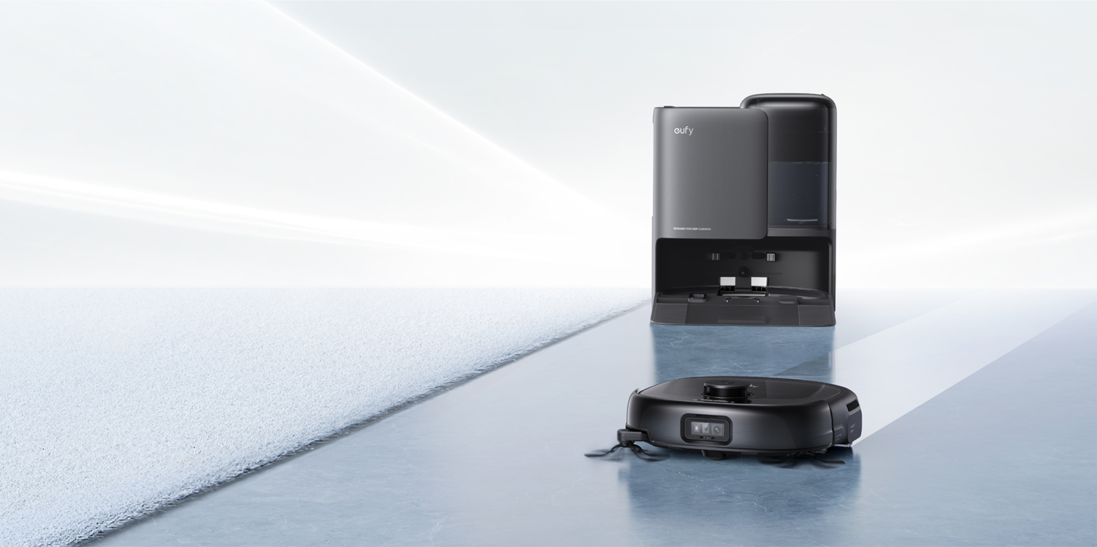 A robot vacuum cleaner next to a machine