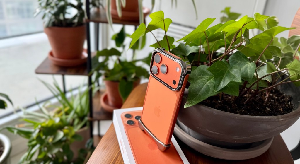 An orange cell phone on a table