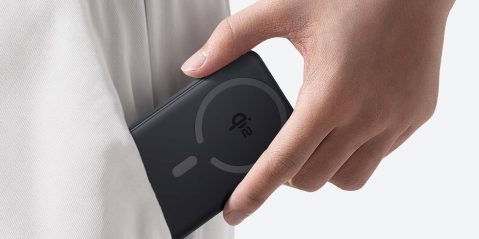 A hand holding a phone in a pocket