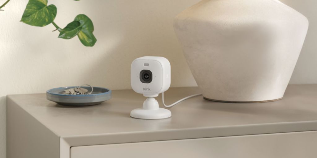 A white camera on a table