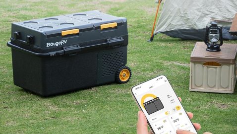 A person holding a phone with a device on the screen