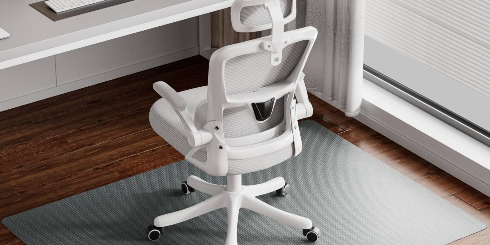 A white chair in front of a desk