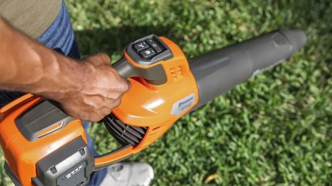 A person holding a blower