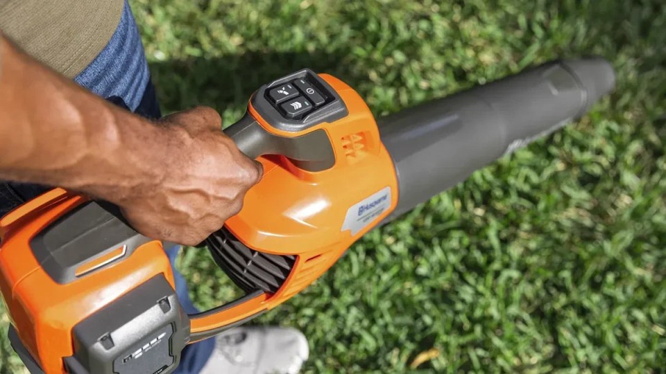 A person holding a blower