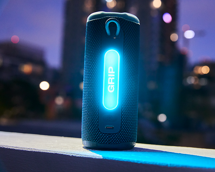 A blue speaker with a lit up light