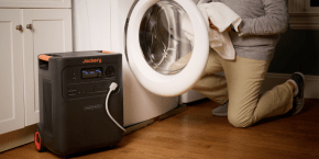 A person holding a white washing machine