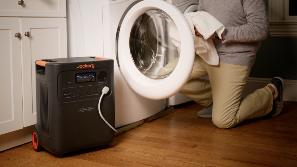 A person holding a white washing machine