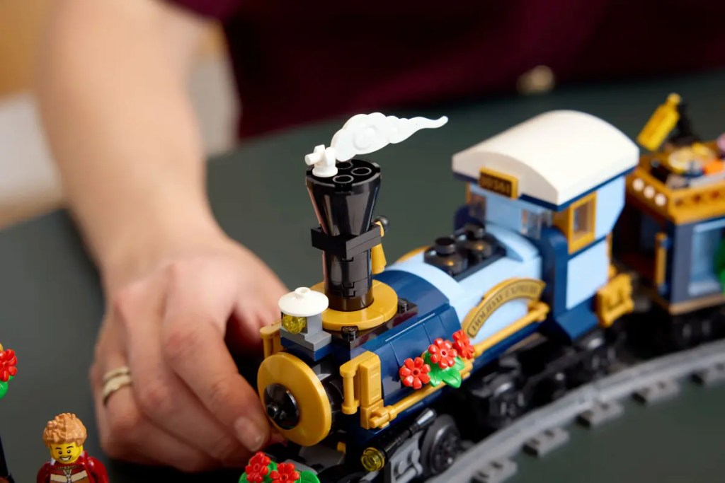 A hand holding a toy train