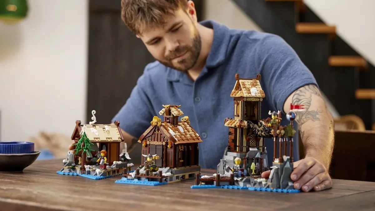 A man sitting at a table with a building set